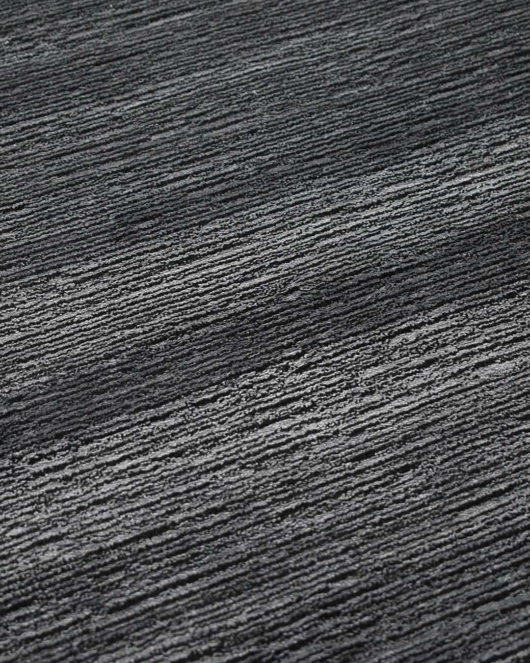 Detailed view of shimmery Quest rug in charcoal colour