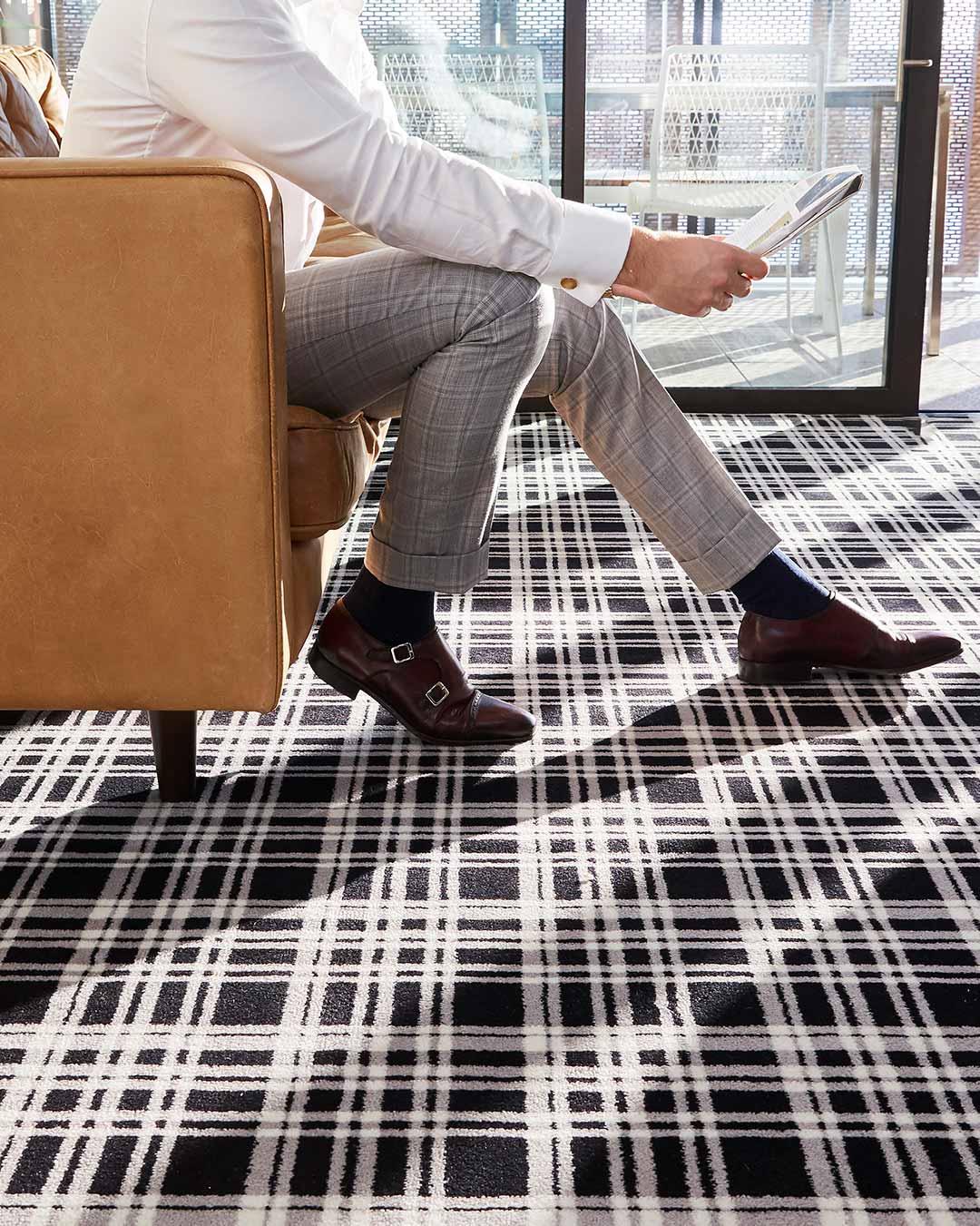 Close up living room view of Alford black and white tartan Axminster carpet