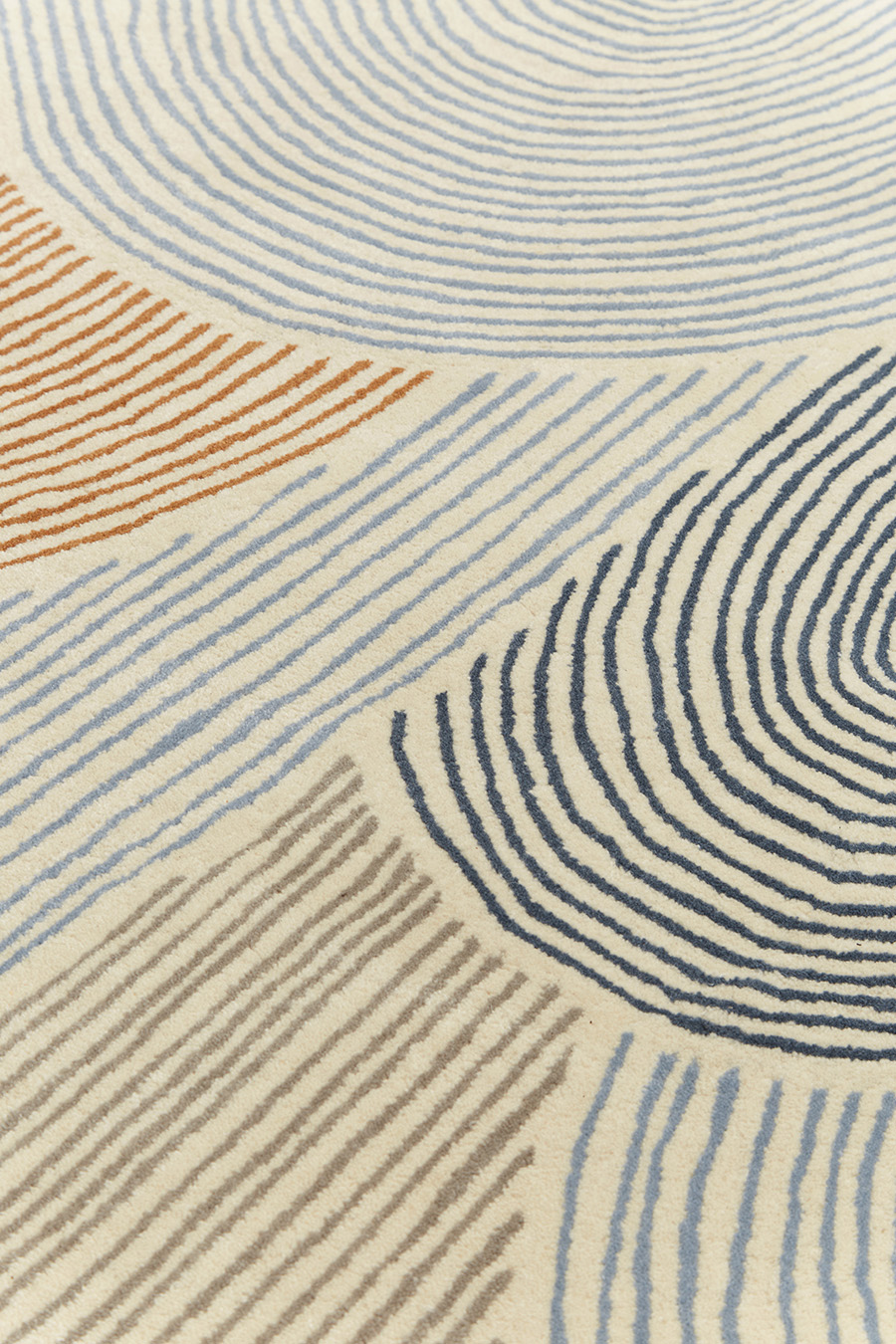 Detailed image of abstract arches Haven rug in brown and blue