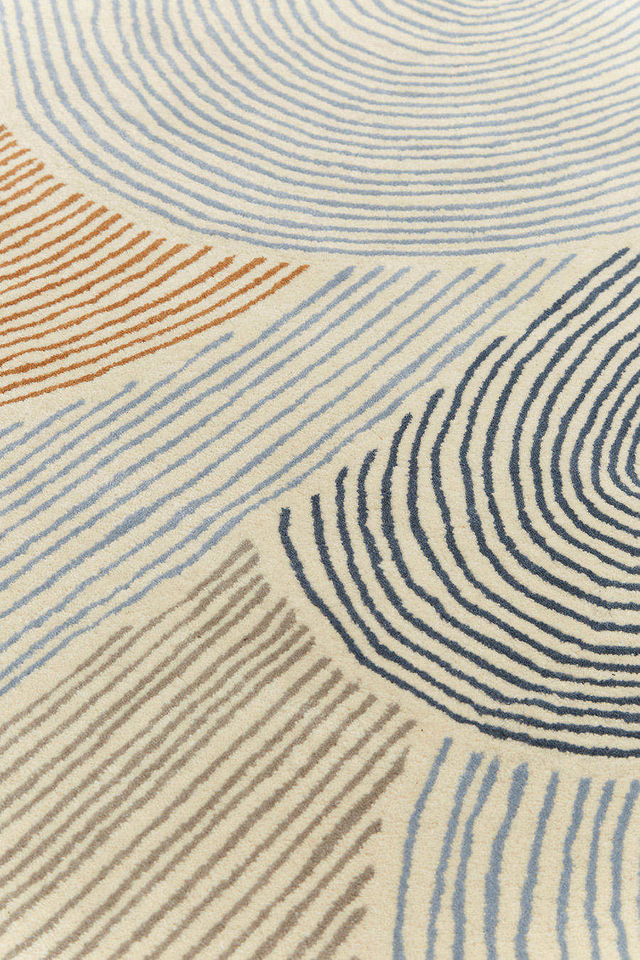 Detailed image of abstract arches Haven rug in brown and blue