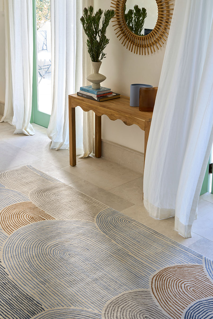 Hallway image of abstract arches Haven rug in brown and blue