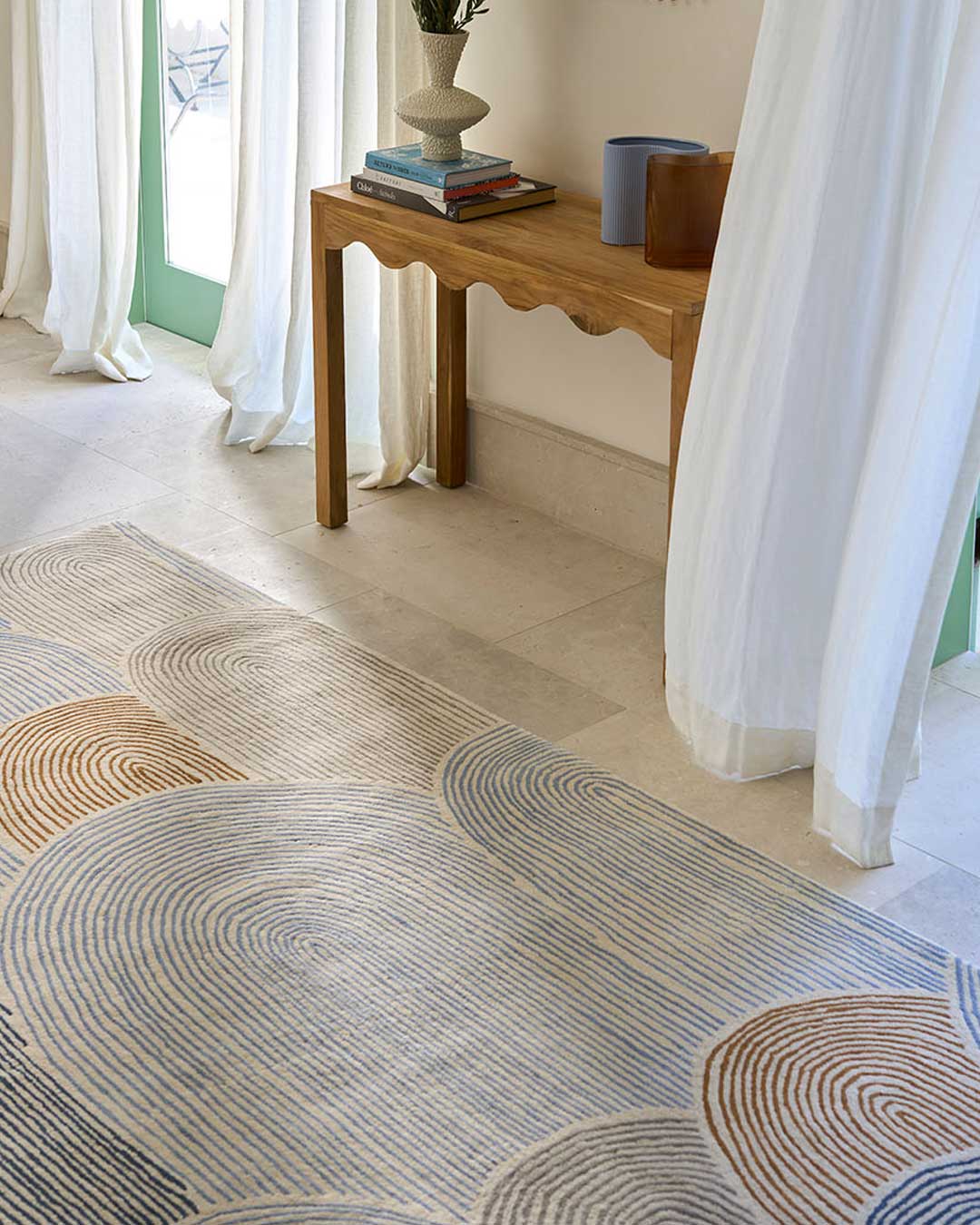 Hallway image of abstract arches Haven rug in brown and blue