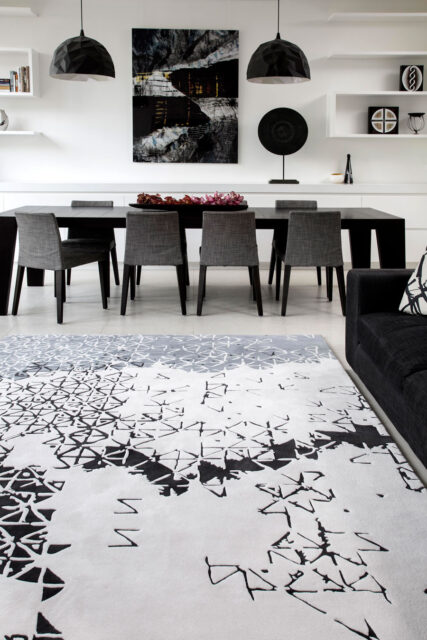 location shot of living room of batik ubud rug by akira in white black and grey pattern