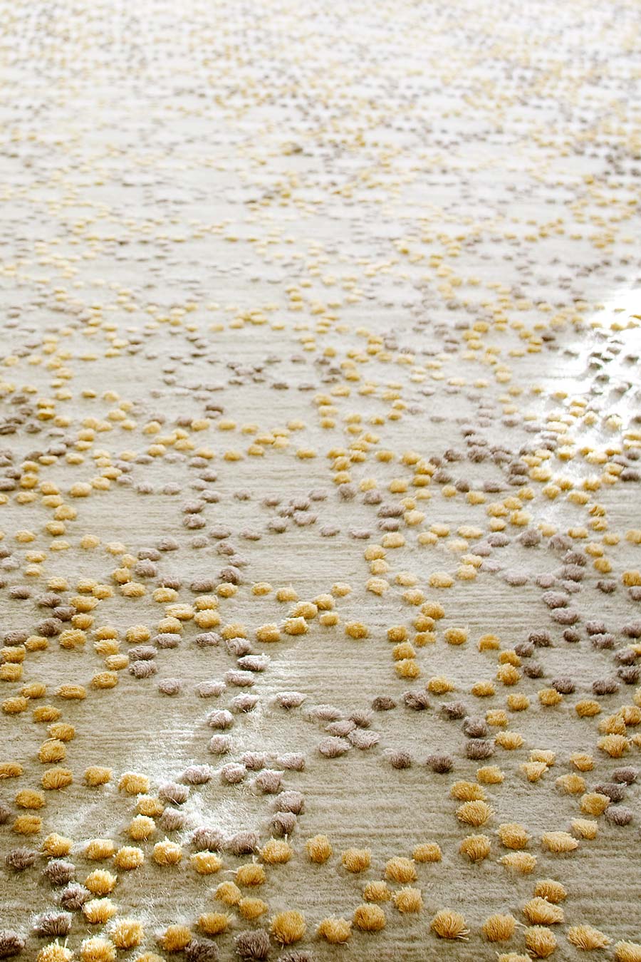 close up of folk rug by bernabeifreeman in yellow and beige circular pattern