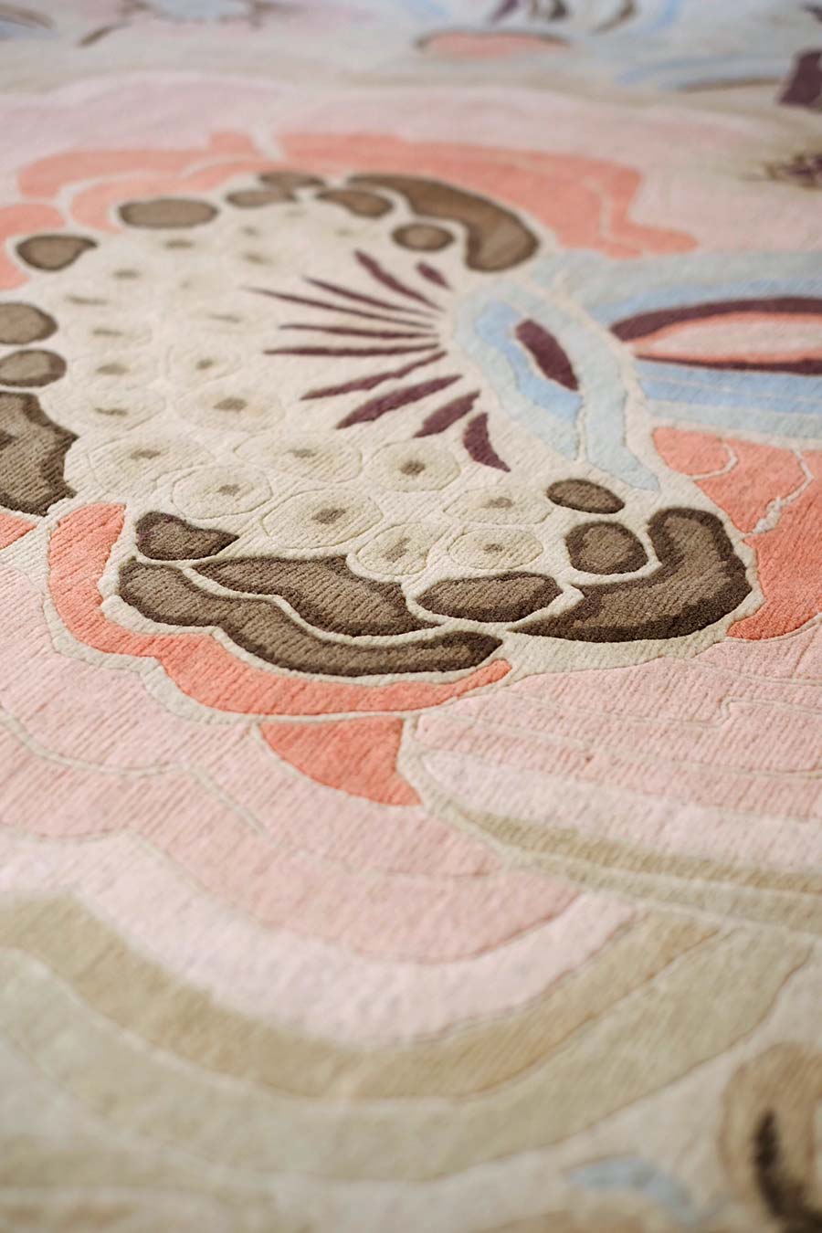 Close up of garden party rug by catherine martin multicoloured floral with beige background