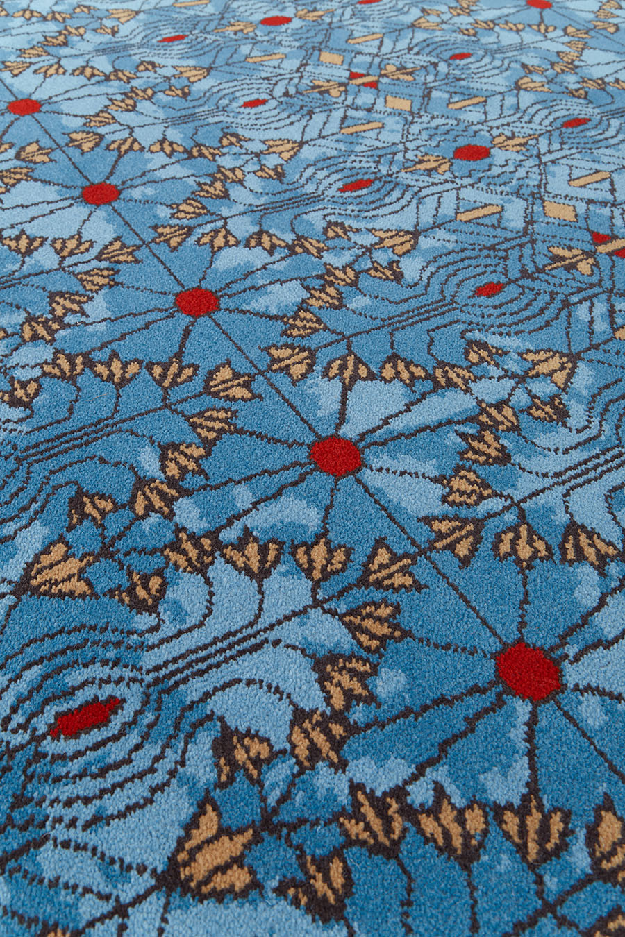 Close up view of patterned Tree Of Life carpet in blue