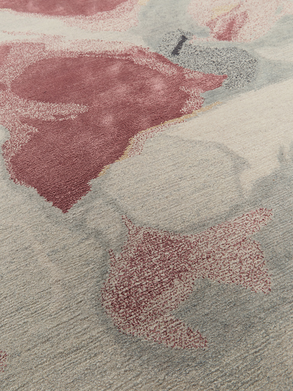 Close up image of organic petale handknot rug by Hare and Klein in pink, beige , charcoal and yellow