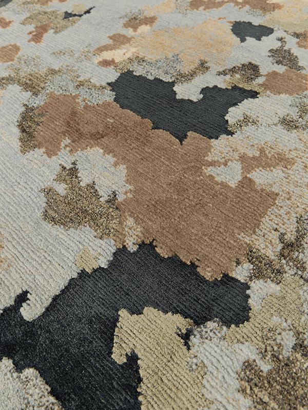 close up image of organic Terrain handknot rug by Hare and Klein in silver,