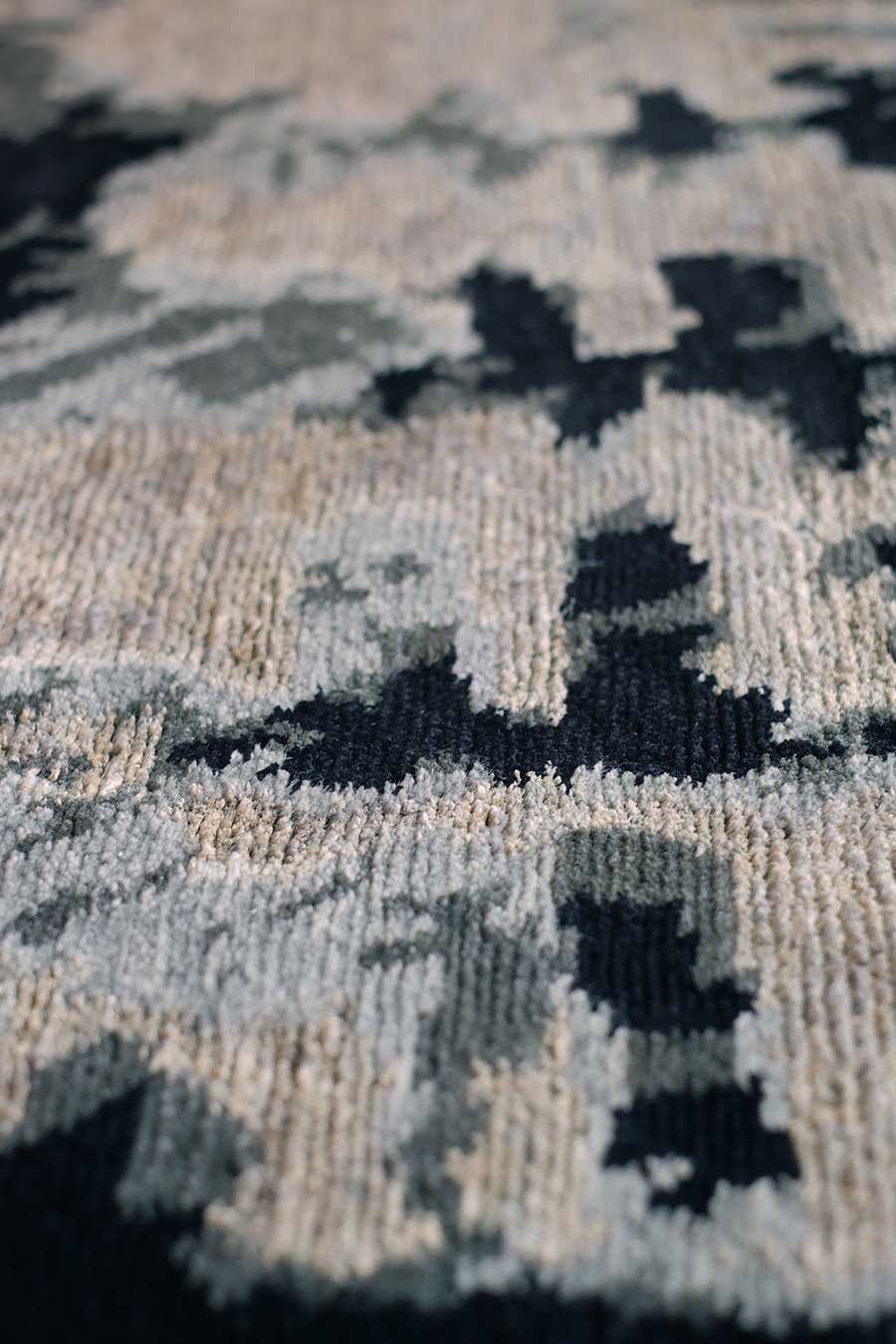 Detailed image of abstract Etched rug by Hare and Klein in grey