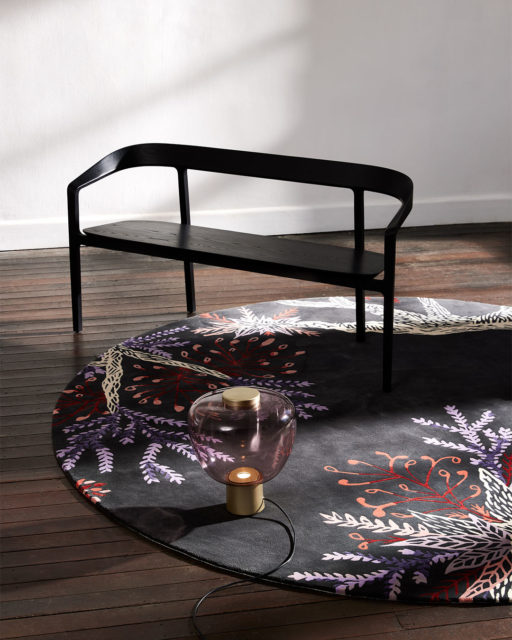 Styled image of round floral Changing Seasons rug by Tamika Grant Iramu