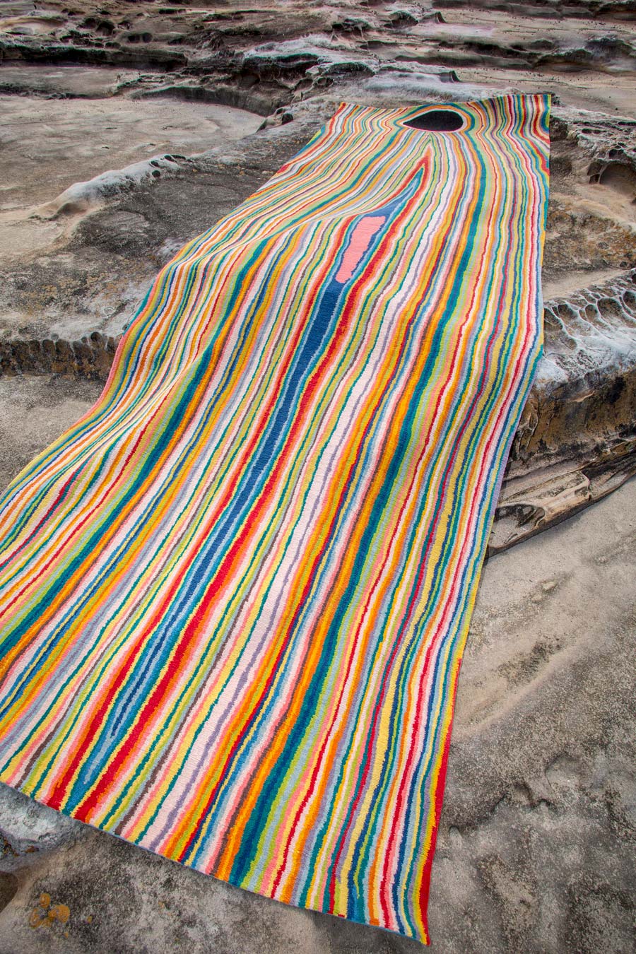 Overhead view of indigenous Untitled 2006 rug in rainbow colours