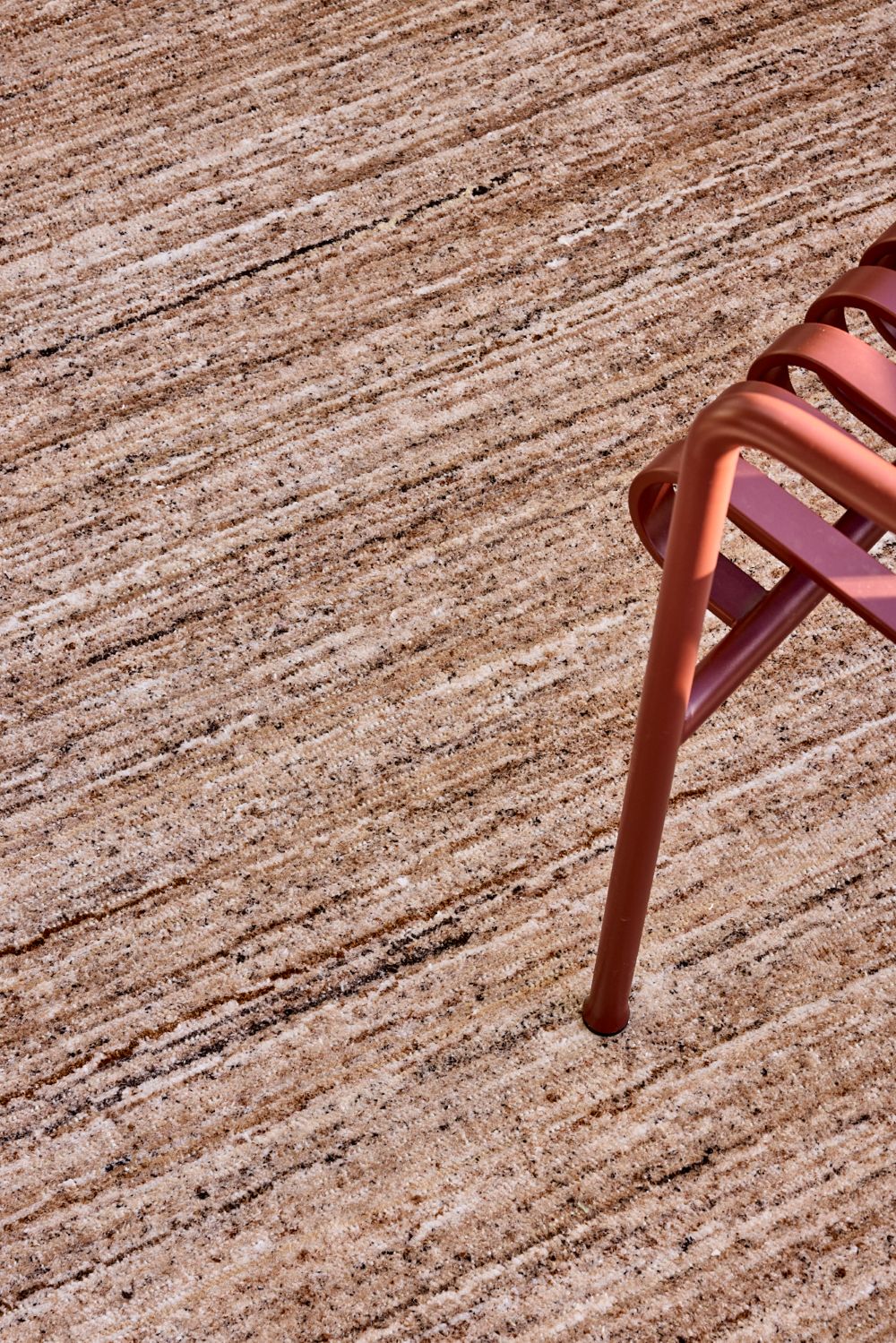 close up image of the Cove Taupe outdoor rug by Designer Rugs, showing its handloom-knotted texture and subtle linen tones that bring warmth and elegance to outdoor spaces.