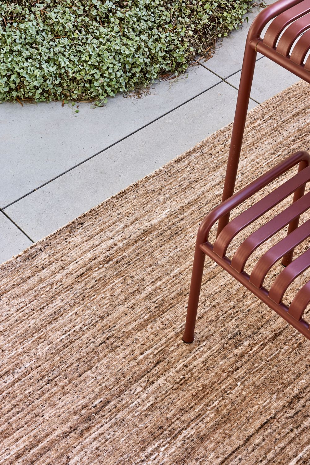 Location image of the Cove Linen outdoor rug by Designer Rugs, showing its handloom-knotted texture and subtle taupe tones that bring warmth and elegance to outdoor spaces.