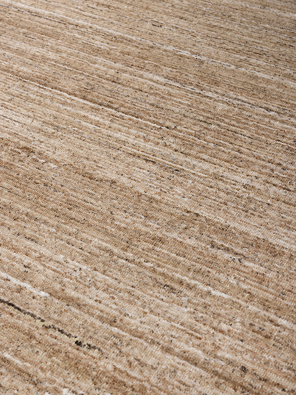 close up image of the Cove Taupe outdoor rug by Designer Rugs, showing its handloom-knotted texture and subtle linen tones that bring warmth and elegance to outdoor spaces.