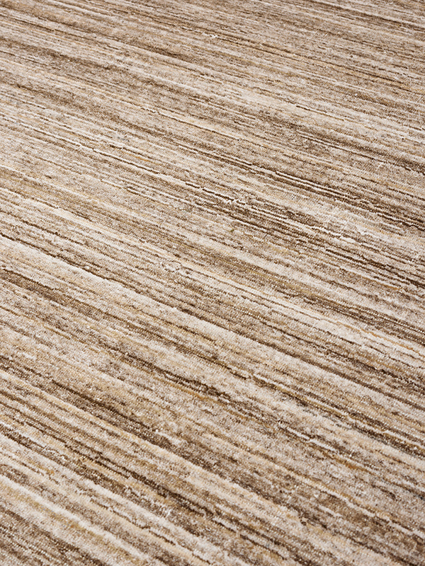 close up image of the Cove Taupe outdoor rug by Designer Rugs, showing its handloom-knotted texture and subtle taupe tones that bring warmth and elegance to outdoor spaces.