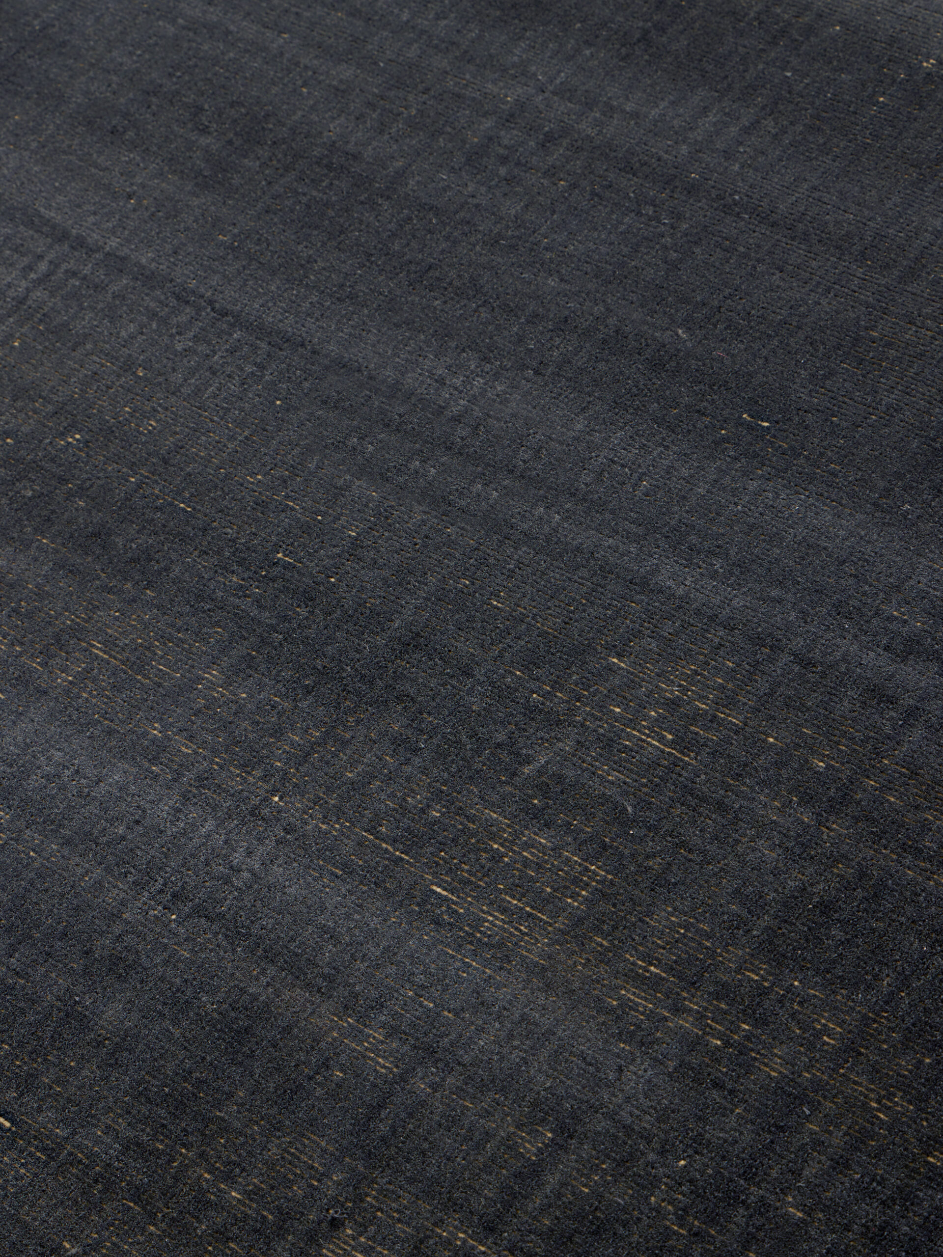 Close up image of the Ravira-charcoal-Honey rug