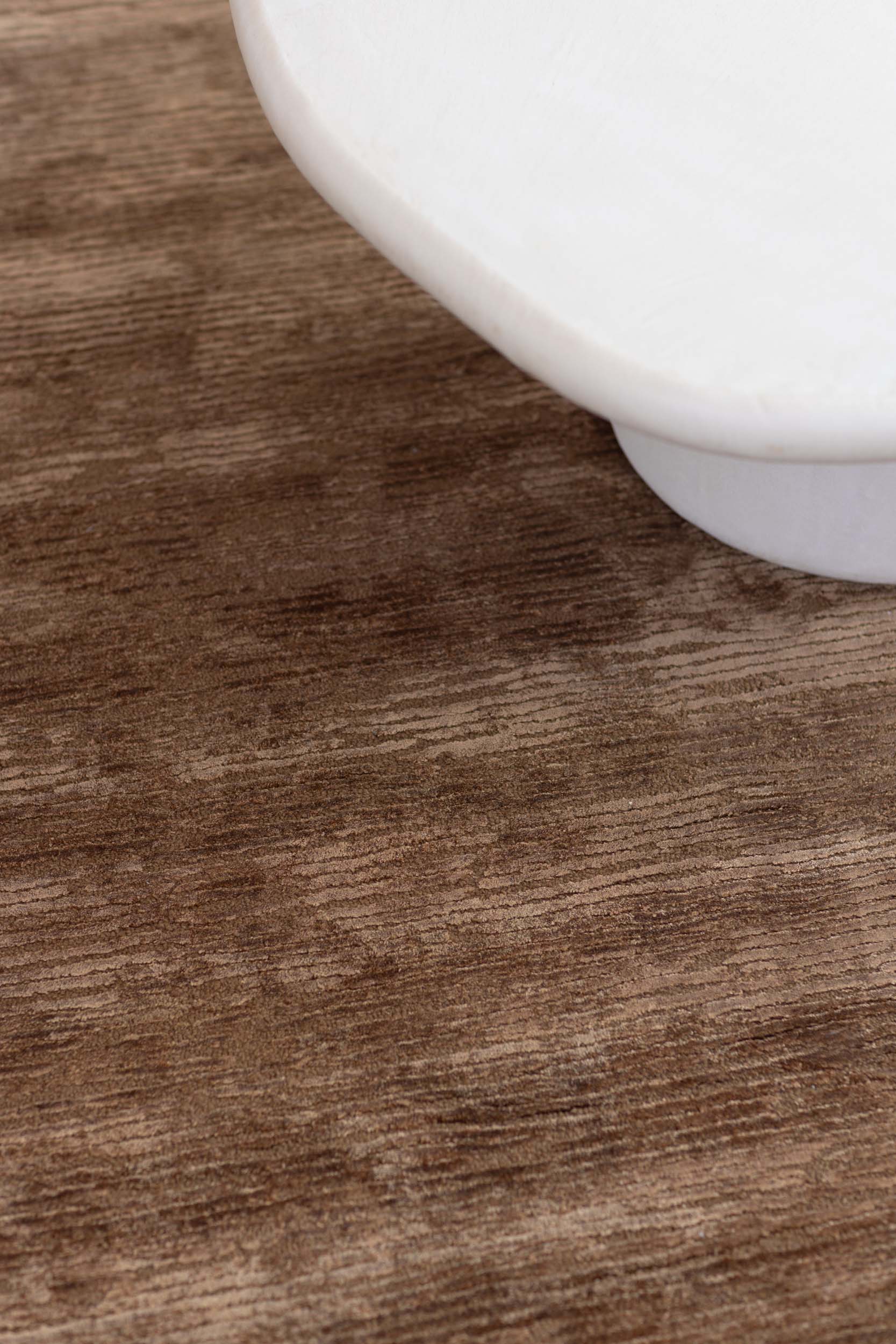 close up image of the rhodium-mahogany-texture rug