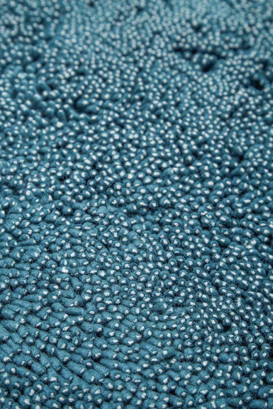 Close up view of textured Coral Shag rug in teal blue colour