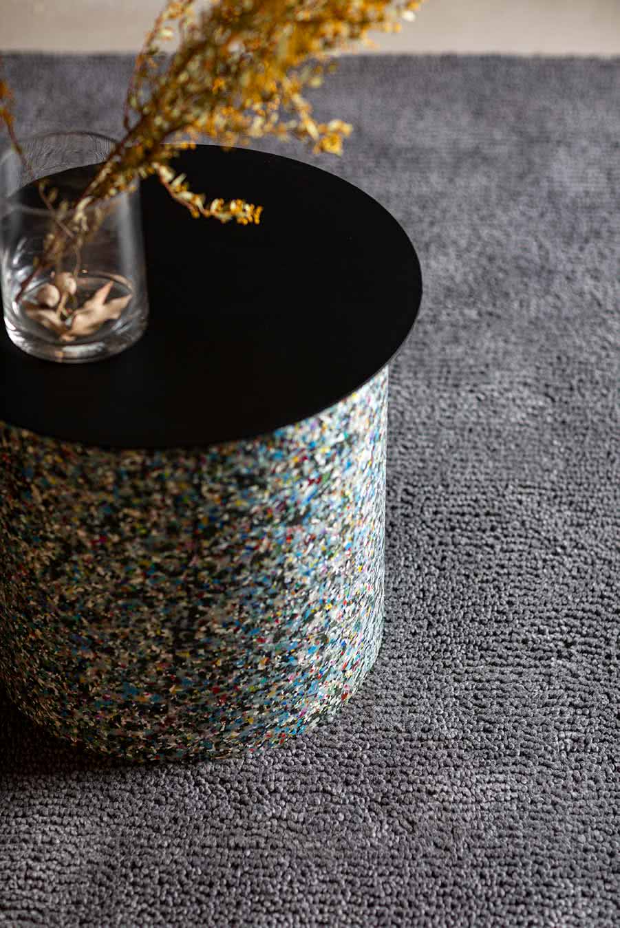 Close up styled view of textured Napoleon Jay Shag rug in grey colour