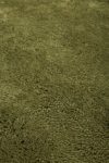 Close up view of textured Napoleon Shag rug in olive green colour