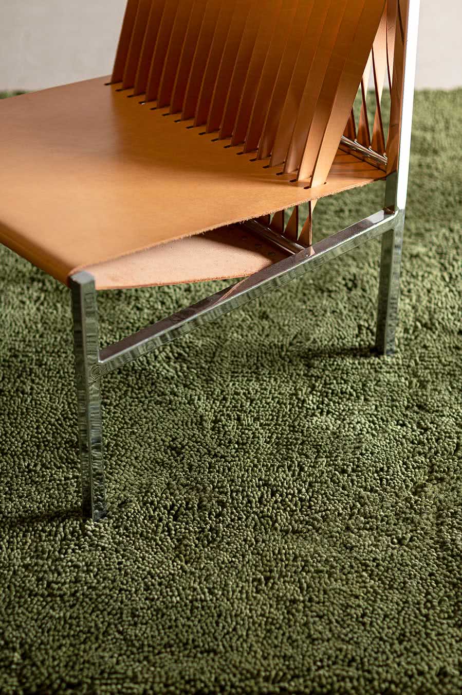 Close up living room view of textured Napoleon Shag rug in olive green colour
