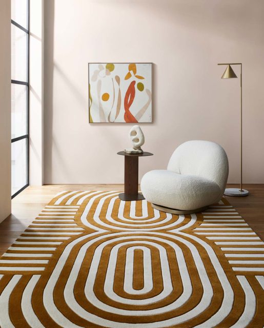 Living room view of modern, art deco Walter rug in mustard.