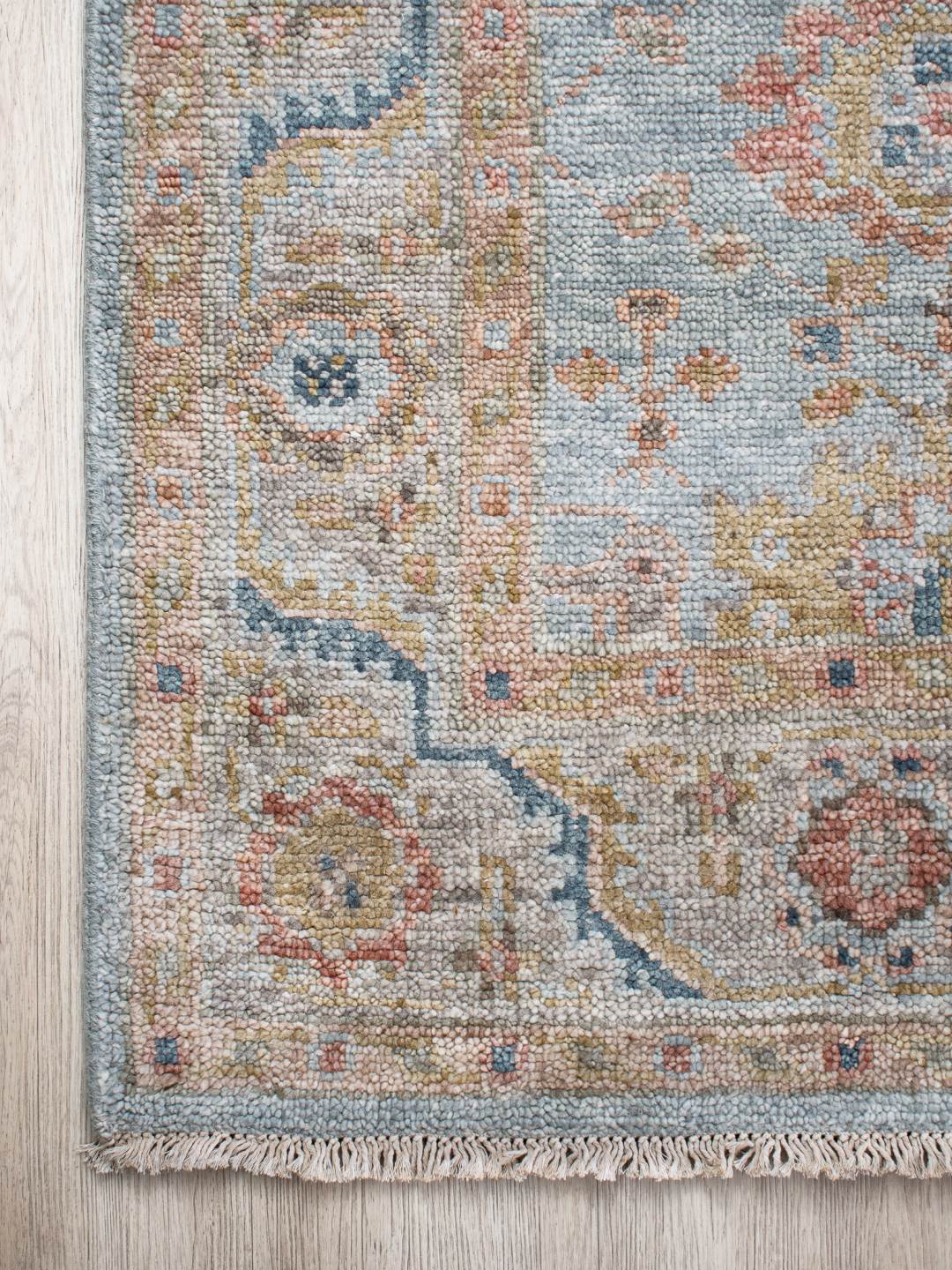 Close-up image of the Haveli Green handknotted rug, showcasing its intricate texture in gree