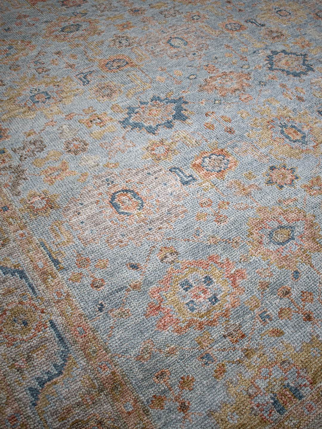 Close-up image of the Haveli Green handknotted rug, showcasing its intricate texture in gree