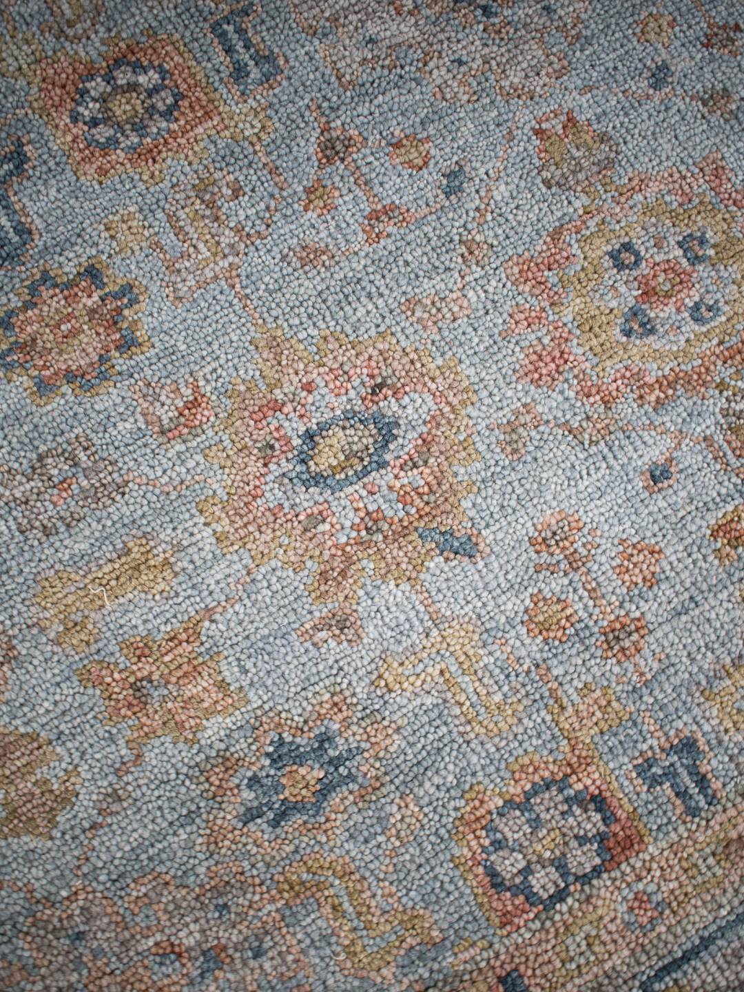 Close-up image of the Haveli Green handknotted rug, showcasing its intricate texture in gree