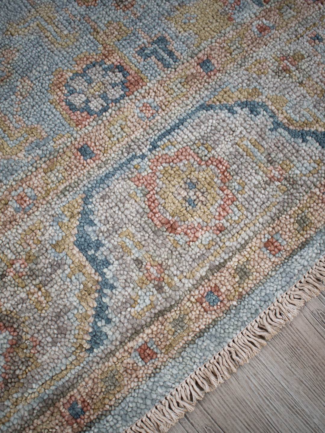 Close-up image of the Haveli Green handknotted rug, showcasing its intricate texture in green tones.