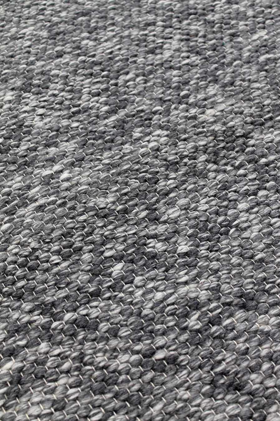 Detailed view of textured Chaser rug in grey colour