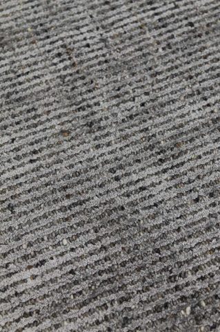 Detailed image of textured Gomez rug in dark grey colour
