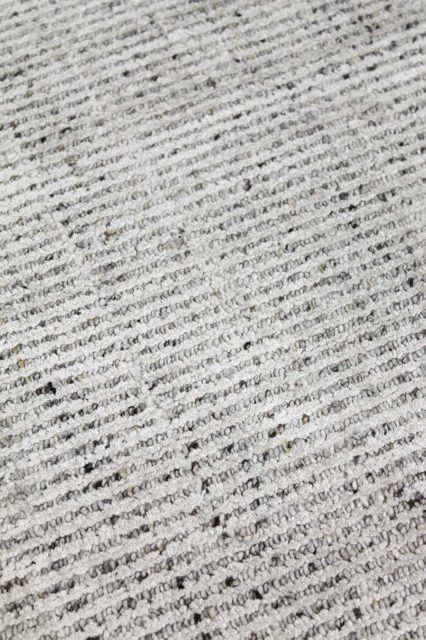 Detailed image of textured Gomez rug in light grey colour