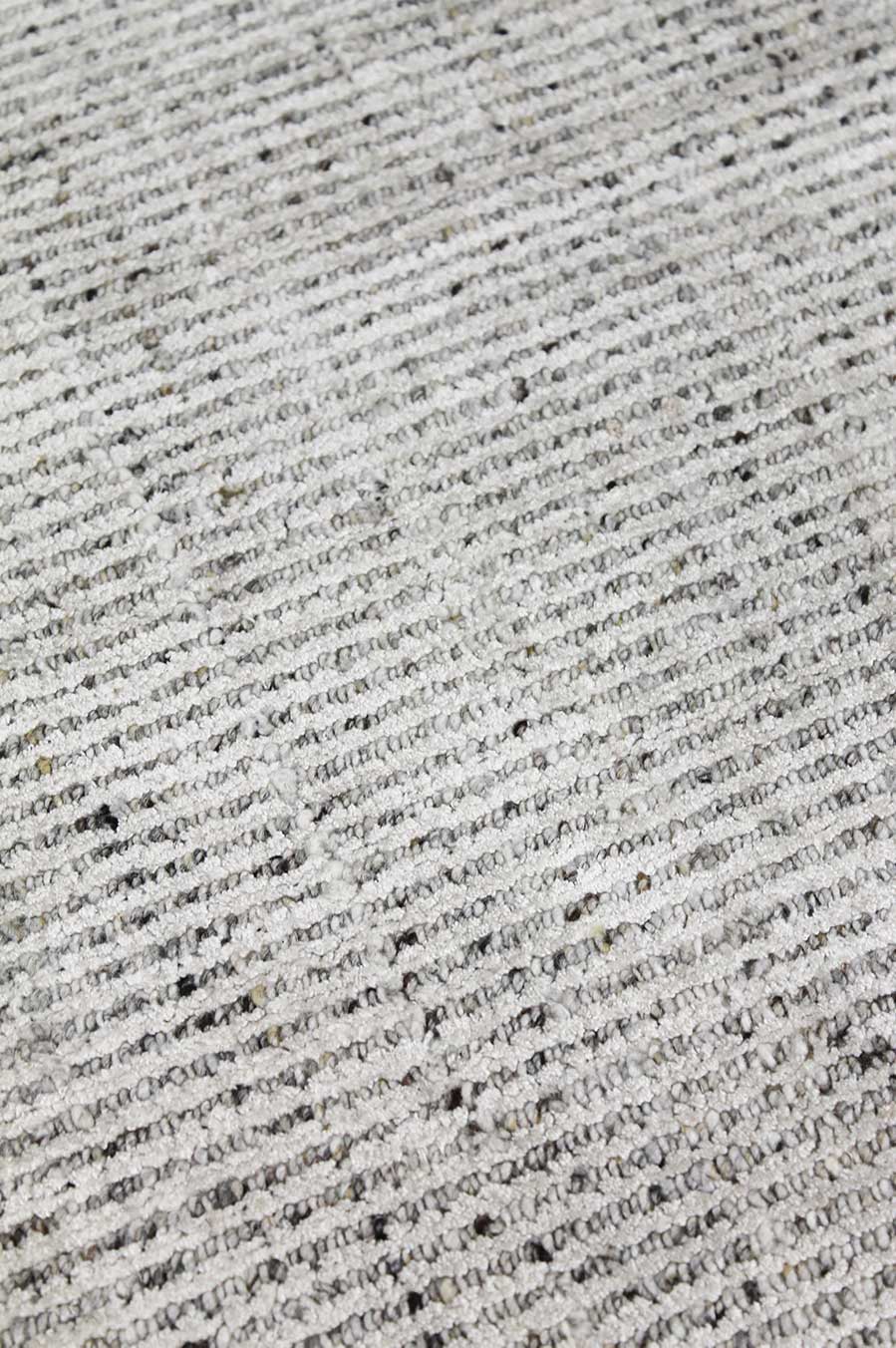 Detailed image of textured Gomez rug in light grey colour
