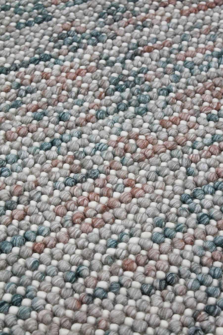 Close up view of textured Marble rug in pink and blue colour