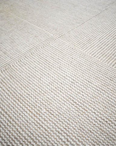Detailed image of textured Plait Box rug in beige colour