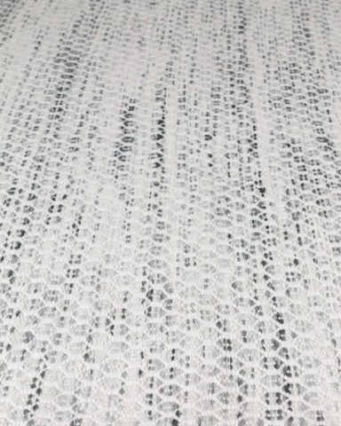 Detailed image of textured Plait Hive rug in ivory colour