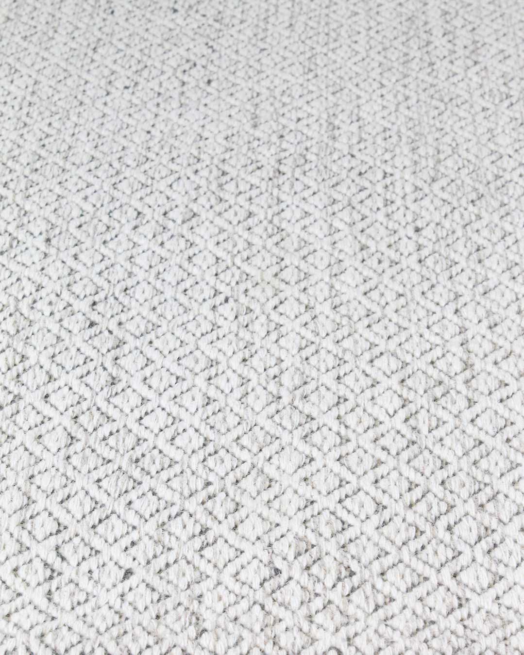 Detailed image of textured Plait Pastille rug in ivory colour