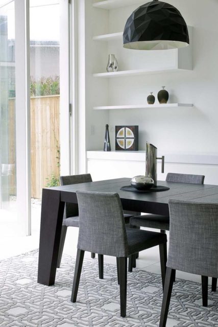 Dining room view of the classic, geometric patterns of our Leon rug un white and light grey