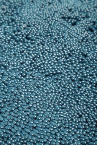 Close up view of textured Coral Shag rug in teal blue colour