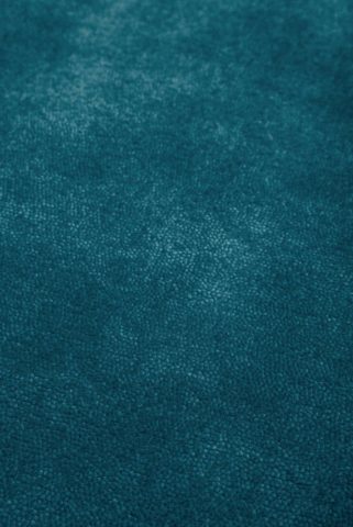 Close up view of textured Napoleon Cut Pile rug in teal colour