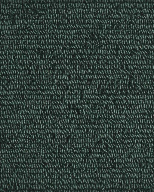 Close up view of textured Napoleon Tip Shear Loop rug in dark green colour